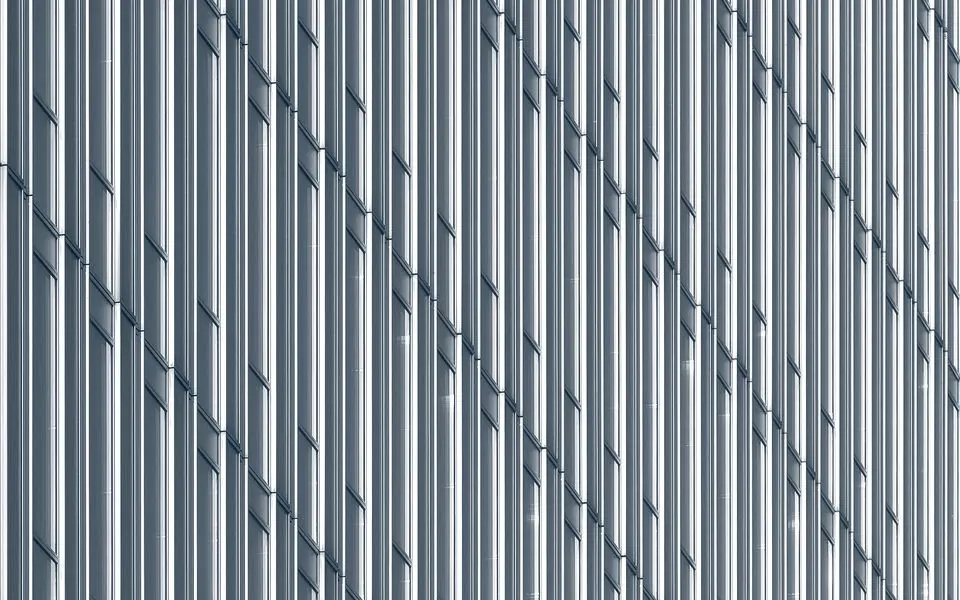 A dense field of thin vertical mullions across a tall facade.